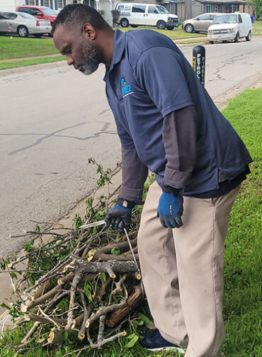 Outdoor area being cleared of waste and debris.