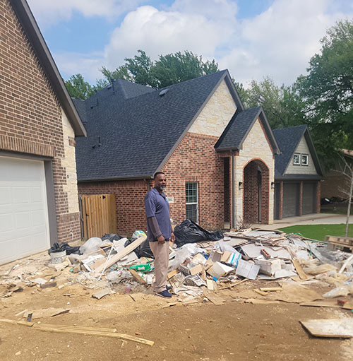 Workers handling large furniture removal from a house.